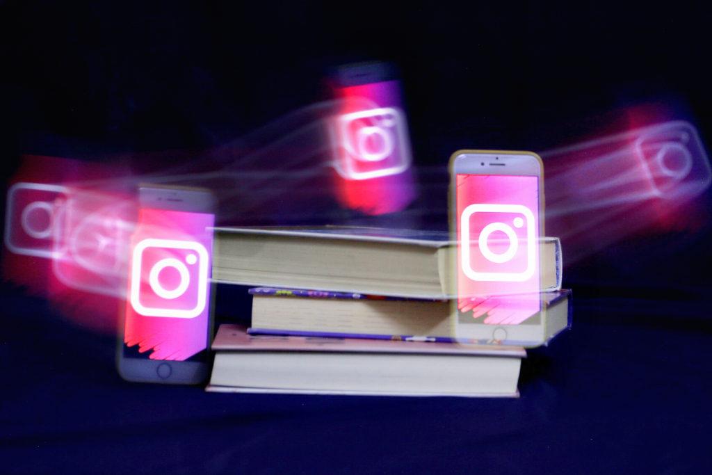 Kuvassa Instagram-logot leijuvat kirjapinon ympärillä.